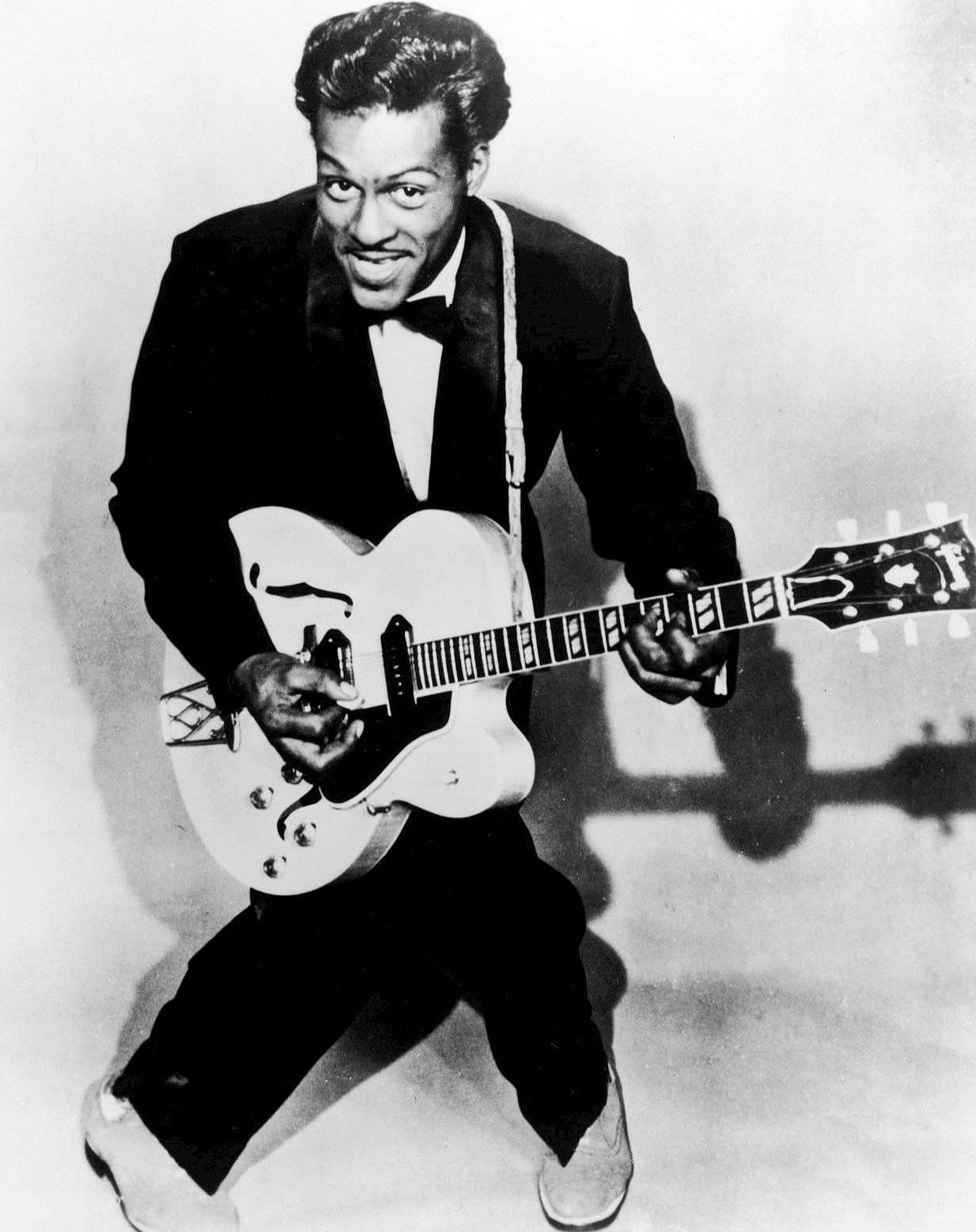 Chuck Berry performing with his guitar.