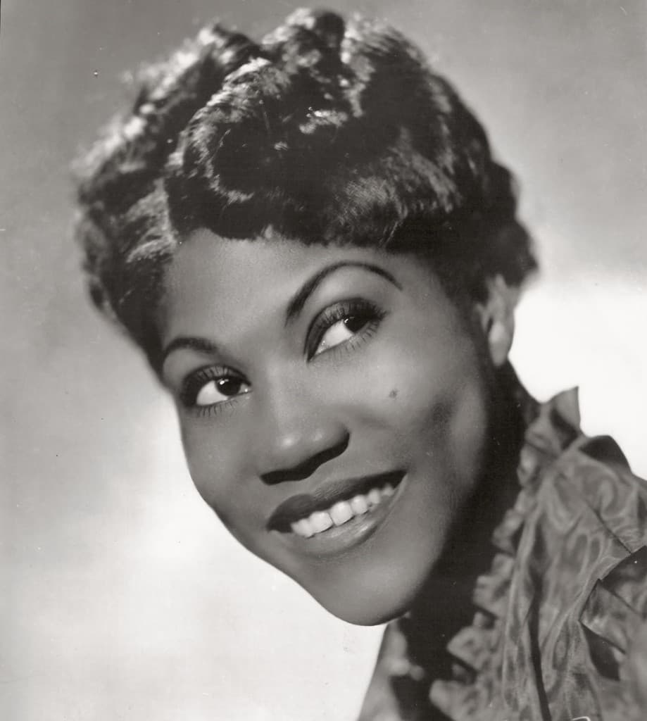 Portrait of Sister Rosetta Tharpe with her guitar.